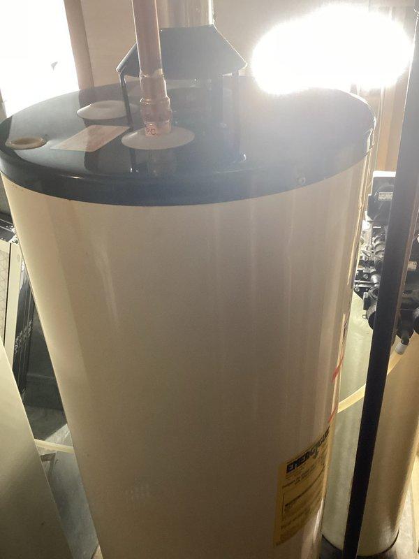 Diagnosed natural gas water heater leaking through tank during fill cycle. Inspection confirmed internal tank failure with water leaking from bottom. Recommended replacement with new 40-gallon atmospheric vent NG water heater, and customer will schedule installation appointment.