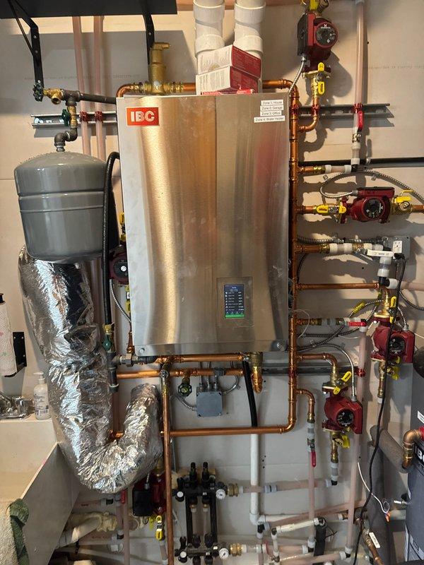 Arrived to assess in-floor heating issue where certain areas of the home were not properly heating. Inspected IBC boiler system and associated piping network. Diagnosed insufficient flow in living room loop; adjusted circulation pump from medium to high speed setting to improve heat distribution throughout the zone.