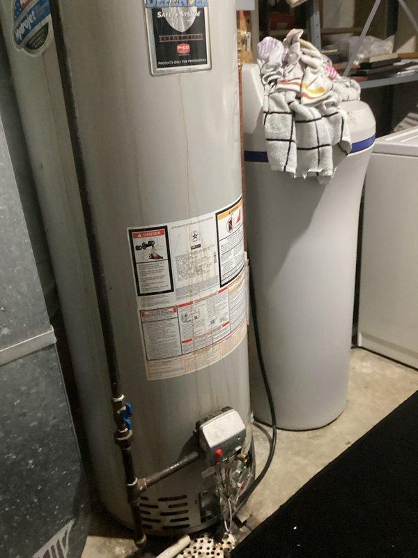 Responded to service call for water heater issues. Upon inspection, diagnosed faulty gas valve on existing unit. Provided customer with options including replacement of valve or installation of new water heater. Documented condition of current installation with photos showing control panel with reset button, drainage configuration, and existing plumbing connections.