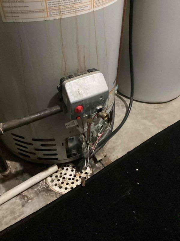 Responded to service call for water heater issues. Upon inspection, diagnosed faulty gas valve on existing unit. Provided customer with options including replacement of valve or installation of new water heater. Documented condition of current installation with photos showing control panel with reset button, drainage configuration, and existing plumbing connections.