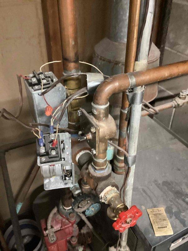 Diagnosed split-level home with dual thermostat system where basement zone continuously ran without responding to temperature adjustments. Inspection revealed faulty blower motor causing overheating issues in downstairs zone. Arranged for technician Rusty to return with replacement parts to restore proper system function and zoning control.