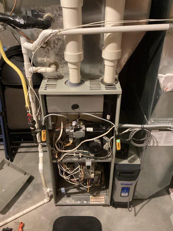 Performed standard tune-up maintenance on an air handler system with visual inspection of furnace unit and associated PVC exhaust ventilation. Inspected internal components including control board, wiring connections, and mechanical parts while system panel was removed. All systems functioning normally; no issues identified during service.