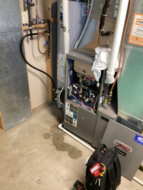 Responded to callback regarding water leakage from furnace following water heater installation. Inspection revealed damaged PVC intake pipe sustained during recent water heater replacement. Performed repair of PVC intake connection and tightened loose electrical components. Documented that additional internal components need to be ordered to complete the repair.