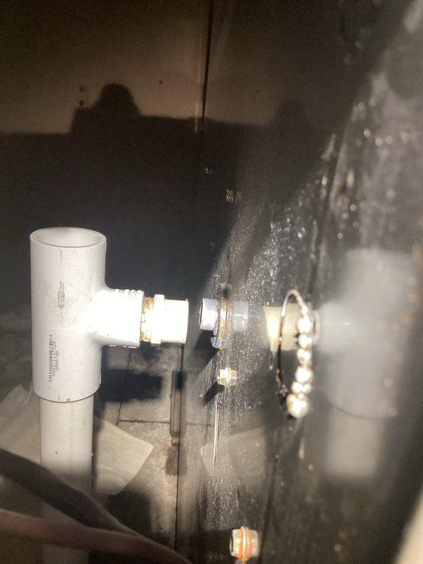Responded to furnace service call for reported condensation drain leak. Diagnosed and repaired leaking PVC condensate drain pipe by applying adhesive to seal joint. Also identified loose exhaust boot connection and secured by tightening the metal hose clamp to restore proper sealed connection.