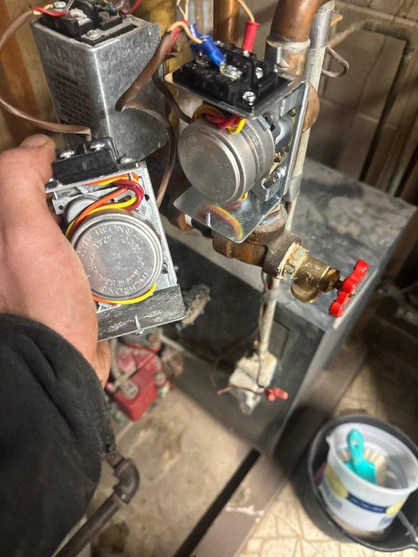 Diagnosed and replaced faulty zone valve actuator on Weil-McLain boiler system that was causing downstairs zone to overheat. Issue was confirmed during arrival at 12:04, with zone valve not properly actuating to control heating distribution.