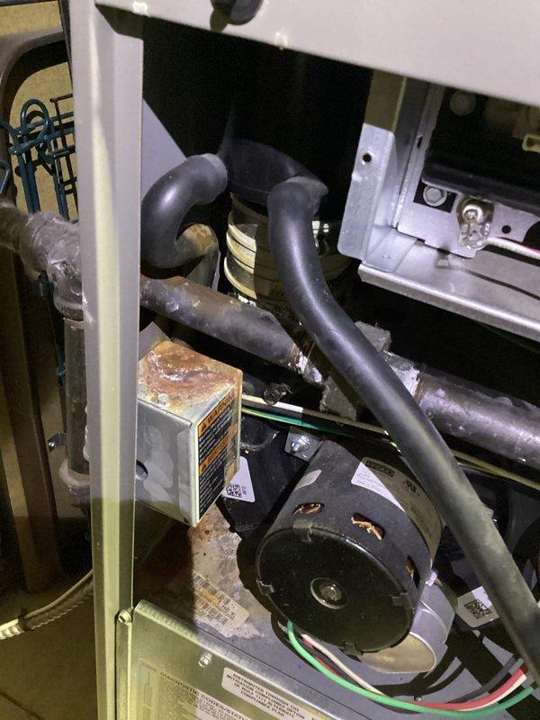 Performed preventative maintenance agreement service on residential furnace. Identified small leak at PVC joint where piping enters furnace. Leak was documented with photos of both exterior exhaust termination and interior furnace connection. Part will be replaced under 10-year parts and labor warranty coverage.