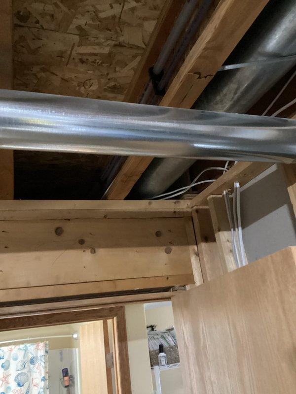 Responded to service call regarding disconnected dryer vent. Upon inspection, discovered the vent was disconnected inside the wall. Documented condition with photos showing both the finished interior view and the exposed mechanical area where the disconnect occurred. Scheduled follow-up visit with senior technician to complete repair.