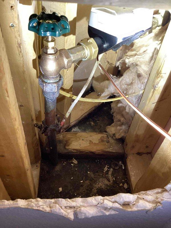 Responded to a callback regarding leaks at the water main before the meter. Inspection revealed a loose packing nut on the main shut-off valve and a loose bleeder valve cap, both causing leakage. Tightened both components and unthreaded the main hex nut that fastens the valve to the mainline. Customer will coordinate with the city to restore water service.