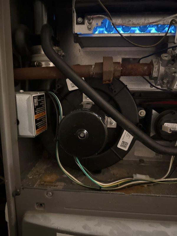 Responded to no heat call for furnace making loud noise. Diagnostic inspection revealed failed inducer motor, evident from 2017 installation with no maintenance history. Removed and replaced Fasco inducer motor assembly (PN: 70211288BC), restored proper flame and system operation. Unit is now functioning correctly.