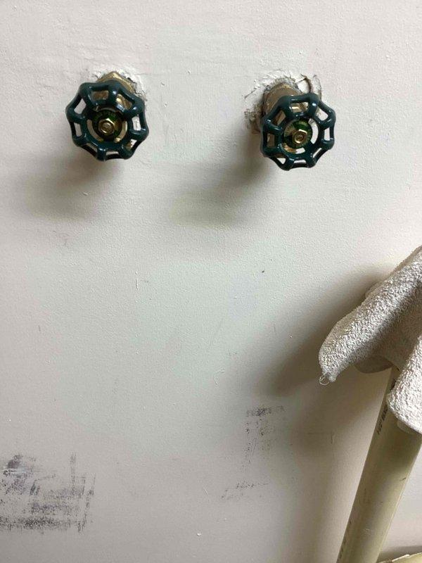 Responded to callback regarding tight cold water valve. Inspected laundry hose bib and found handle operating stiffly as expected with new installation. Adjusted packing slightly to improve operation and educated customer that new valves typically loosen with normal use over time. No leaks present in system.