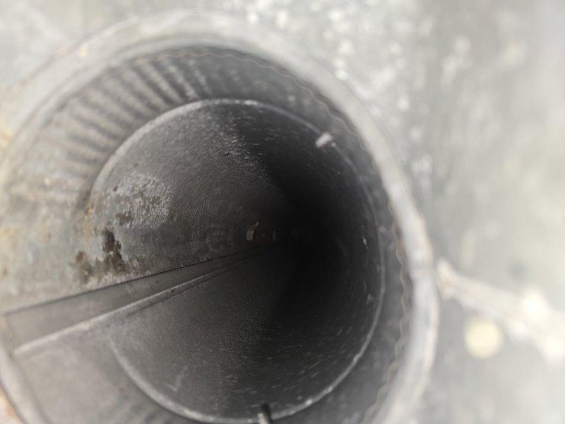 Completed comprehensive duct cleaning service that was included with system installation. Removed accumulated dust and debris from the HVAC ductwork system, thoroughly cleaning all vents to improve system efficiency and air quality. Visual inspection confirmed successful removal of contaminants from circular metal ducts.