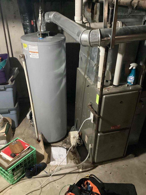 Responded to emergency no-heat call for a Bryant furnace that had previously been serviced by another company without resolution. Upon inspection, found severely corroded burners, failed condensate pump, and frayed blower motor capacitor terminals. Completed service by cleaning burners, bypassing condensate pump, and repairing damaged wiring connections to restore proper heating operation.