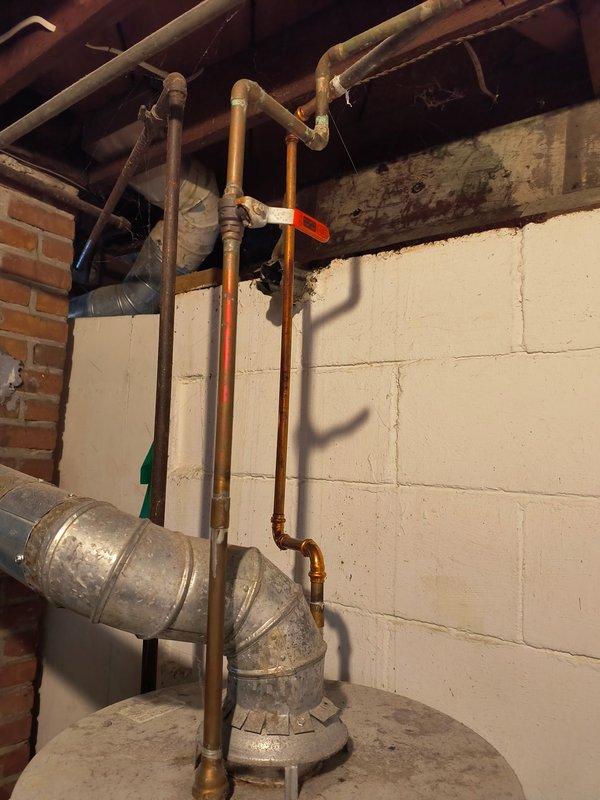 Responded to service call for a pinhole leak in an aging copper supply pipe emitting a water mist in basement/utility area. Located the source of the leak in a 1/2" water line showing significant oxidation and corrosion. Successfully repaired the compromised section of pipe, eliminating the active leak.