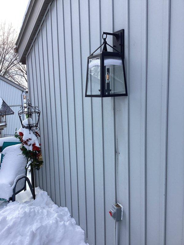 Installed new exterior lantern-style light fixture on client's metal siding per approved estimate. Wired fixture to existing electrical supply and installed safety disconnect switch with weather-resistant enclosure. Verified proper operation of fixture after installation was complete.