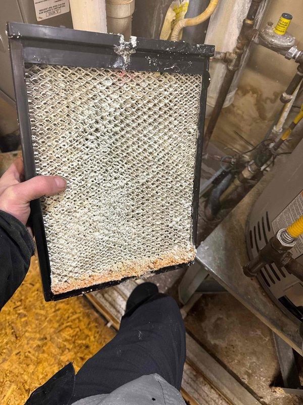 Responded to service call for leak near furnace. Diagnosed leak originating from humidifier with heavily scaled components and severely clogged filter that had not been replaced. Ordered rebuild kit for humidifier restoration and advised proper filter maintenance schedule.