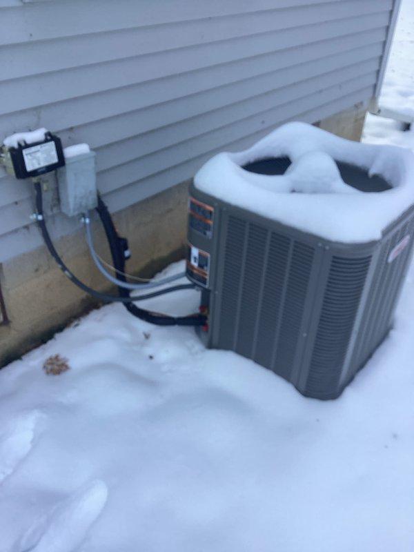 Performed scheduled tune-up service on customer's Lennox furnace system. Completed comprehensive inspection of heating components, verified proper ventilation through PVC exhaust/intake lines, and ensured optimal system performance. Documented exterior AC condenser condition with significant snow accumulation present on unit and surrounding area.