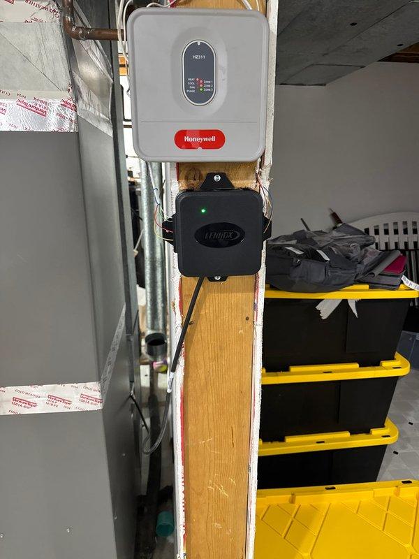 Arrived at customer location for warranty service call. Diagnosed HVAC zoning issues and replaced faulty zone damper and mitigation board under installation warranty. System is now functioning properly with new Honeywell control components installed.