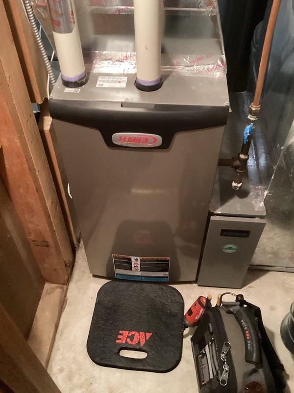 Performed routine furnace tune-up on Lennox system in utility area. Inspected all connections including PVC exhaust/intake piping and verified proper installation with visible primer at joints. System is operating within normal parameters following service.