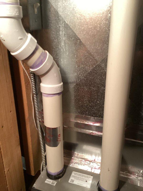 Performed routine furnace tune-up on Lennox system in utility area. Inspected all connections including PVC exhaust/intake piping and verified proper installation with visible primer at joints. System is operating within normal parameters following service.
