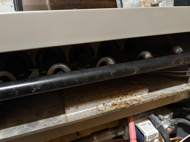 Responded to service call for burner installation and potential humidifier service. Successfully installed new burners in the heating system and verified proper operation through comprehensive testing. Observed significant corrosion and wear on internal components, particularly on the metal tray beneath the burner assembly.