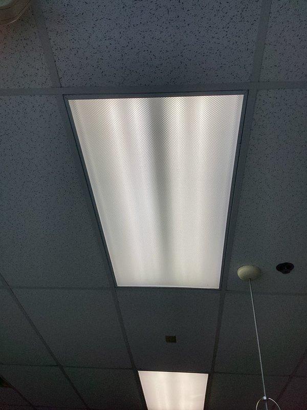 Arrived within scheduled timeframe and diagnosed faulty T8 ballast in ceiling fixture. Replaced defective ballast with new unit, restoring proper lighting function. Inspected electrical panel to ensure proper circuit operation.