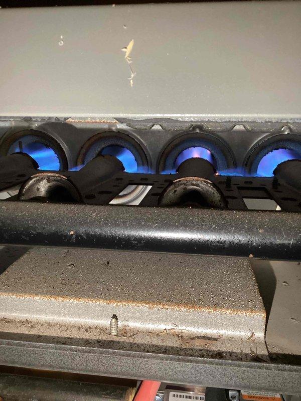 Performed annual maintenance agreement tune-up on residential furnace system. Identified and documented rusty burners during inspection but confirmed proper flame characteristics during combustion test. Customer was informed of findings for future monitoring.