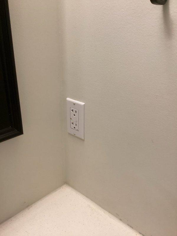 Addressed multiple code violations identified during home inspection. Corrected improperly wired GFCI outlet in upstairs bathroom by reversing hot and neutral wires. Installed GFCI protection for washing machine outlet as required by code. Eliminated double-tapped breaker by pigtailing kitchen/dining lights hot wire and transformer wire to ensure only one wire connection per breaker terminal.