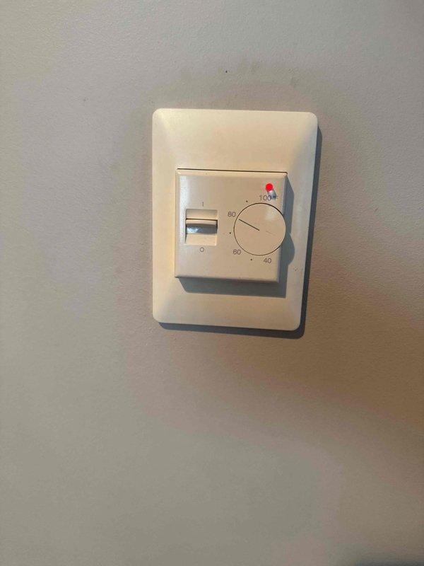 Responded to service call for in-floor heating system with two zones where one zone was not providing heat to the basement area. Inspected thermostats controlling both zones and found they were operational but required dial manipulation to activate heating. Identified thermostat model for potential replacement, though customer opted to defer replacement and will contact for follow-up if needed.