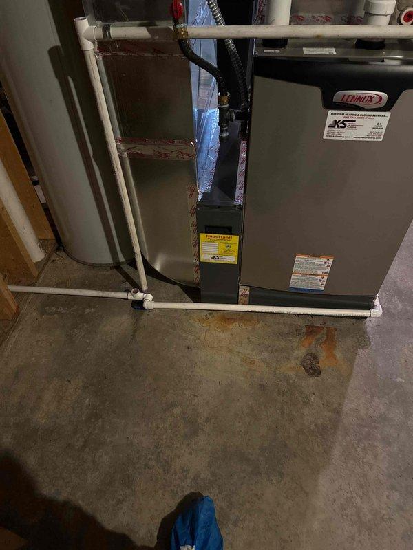 Diagnosed and corrected issue with new Lennox furnace exhibiting condensate leak due to improper pitch of heat exchanger. Warranty service performed to replace heat exchanger and installed condensate pump to replace inadequate back-pitched drain line that was interfering with filter housing. Noted electrical work required - customer advised to contact electrician.
