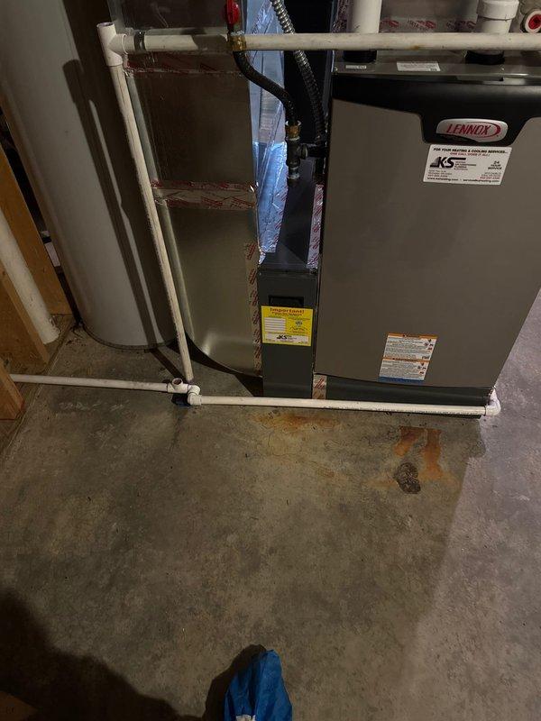 Diagnosed and corrected issue with new Lennox furnace exhibiting condensate leak due to improper pitch of heat exchanger. Warranty service performed to replace heat exchanger and installed condensate pump to replace inadequate back-pitched drain line that was interfering with filter housing. Noted electrical work required - customer advised to contact electrician.
