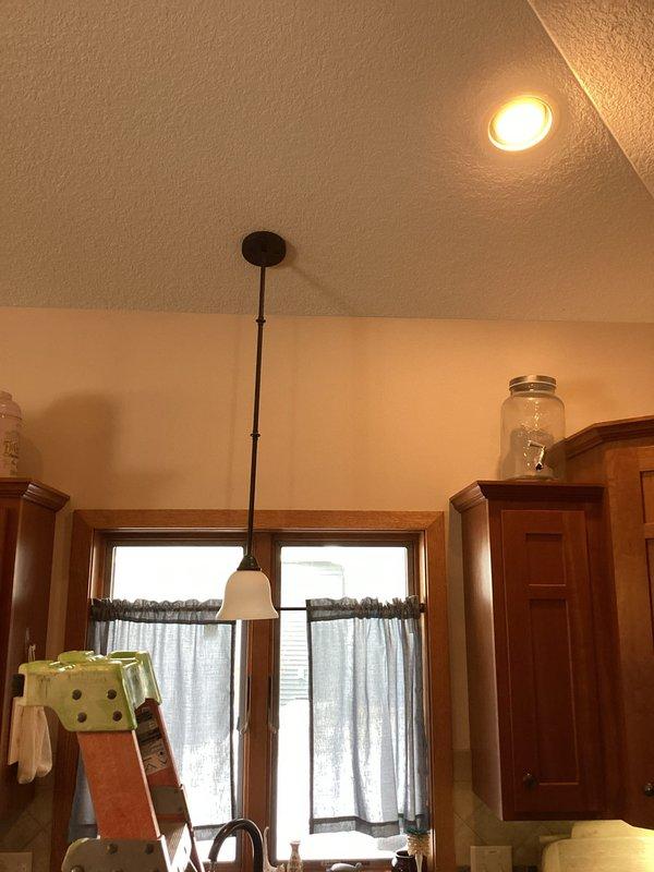 Responded to service call regarding lighting issues in kitchen area. Inspected recessed ceiling can light that was dimming and not functioning properly. Also examined pendant light fixture over sink that was intermittently operational. Verified proper voltage at both locations. Recommended replacement bulbs for the ceiling can light and suggested installing a new fixture for the sink pendant light to resolve the flickering issues.