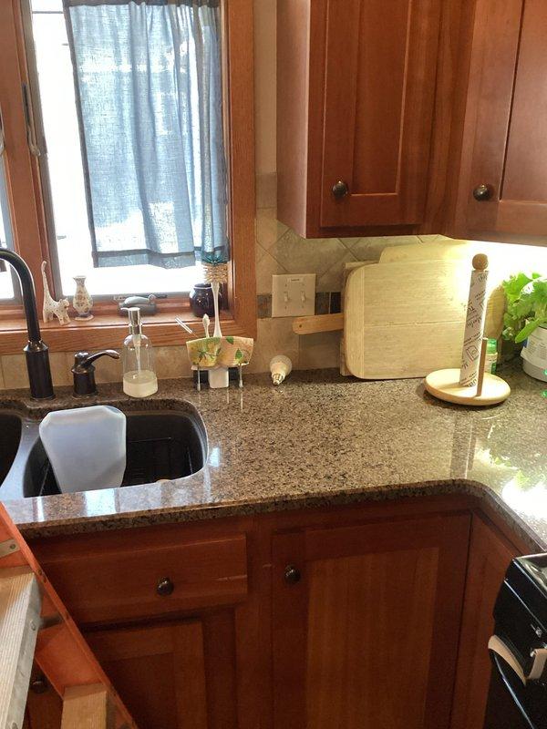 Responded to service call regarding lighting issues in kitchen area. Inspected recessed ceiling can light that was dimming and not functioning properly. Also examined pendant light fixture over sink that was intermittently operational. Verified proper voltage at both locations. Recommended replacement bulbs for the ceiling can light and suggested installing a new fixture for the sink pendant light to resolve the flickering issues.