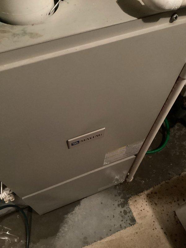 Responded to no-heat service call for Maytag HVAC system. Diagnosed issue as water accumulation around unit due to clogged condensation drain line. Successfully cleared blockage, restoring proper drainage and system operation.