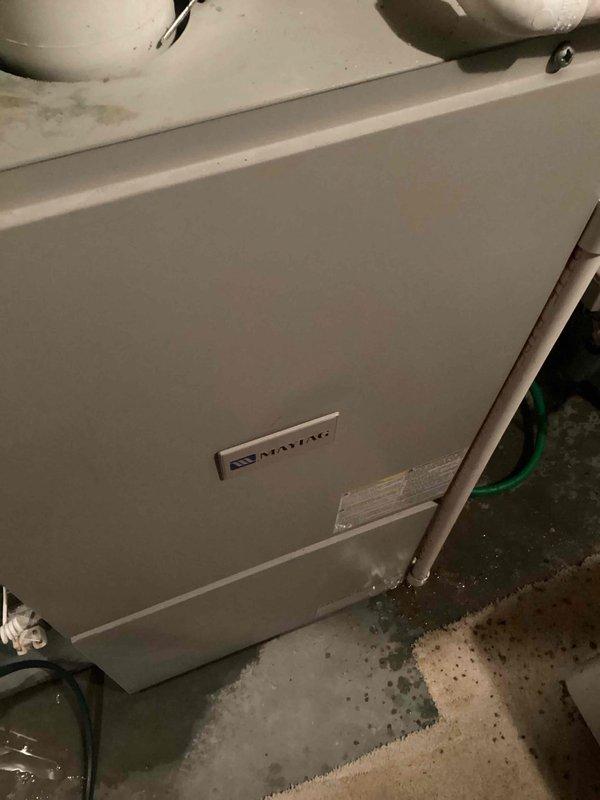 Responded to no-heat service call for Maytag HVAC system. Diagnosed issue as water accumulation around unit due to clogged condensation drain line. Successfully cleared blockage, restoring proper drainage and system operation.