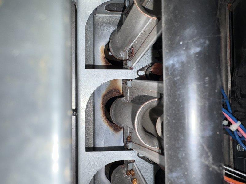 Responded to service call for insufficient heat where furnace was not maintaining thermostat temperature. Diagnostic inspection revealed a failed blower motor as the primary issue, evidenced by significant corrosion at burner assembly connections and electrical control system problems. Recommended replacement of motor or complete system due to component failure affecting heating performance.