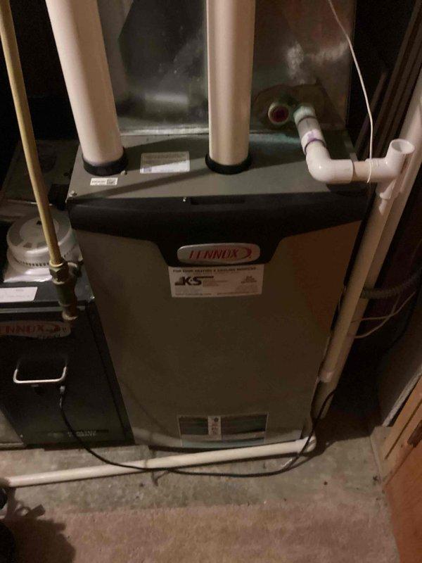 Performed scheduled annual tune-up maintenance service on a Lennox residential furnace system. Conducted full inspection of the unit including verification of proper venting through PVC exhaust/intake pipes and condensate drainage system. All components were found to be in normal operating condition with no issues identified.