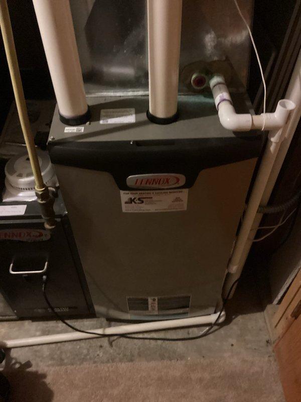 Performed scheduled annual tune-up maintenance service on a Lennox residential furnace system. Conducted full inspection of the unit including verification of proper venting through PVC exhaust/intake pipes and condensate drainage system. All components were found to be in normal operating condition with no issues identified.