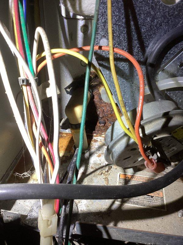 Responded to no heat complaint and found severely clogged heat exchanger with significant corrosion and deterioration. Inspection revealed extensive rust on multiple components including metal brackets and internal connections. Replacement of unit recommended due to safety concerns and irreparable damage.