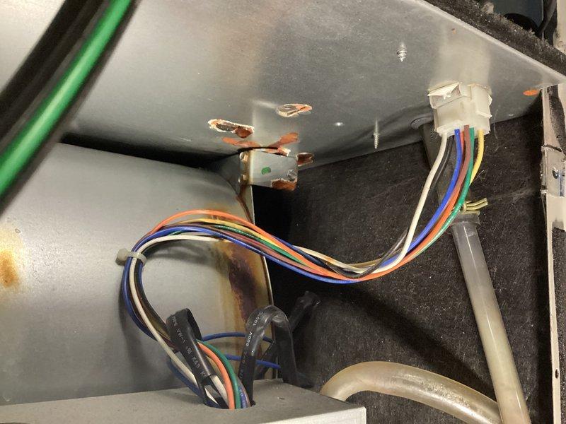 Performed scheduled air handler tune-up on furnace that was reported to make loud noise during startup. Upon inspection, discovered secondary heat exchanger leakage with visible corrosion and oxidation on internal components. Recommended equipment replacement due to unit age and extensive repair requirements.