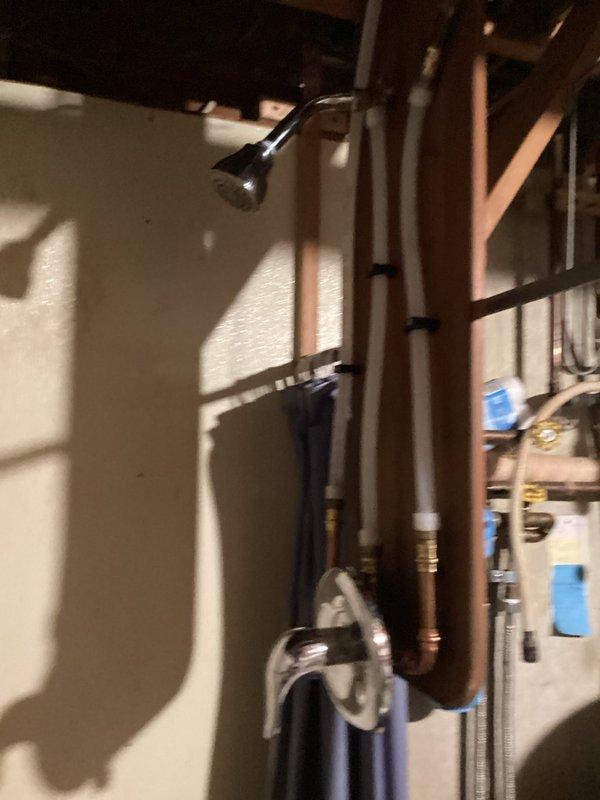 Successfully installed new shower valve and trim kit with shower head riser in laundry room. Completed copper line installation for shower head and connected all necessary plumbing components. Water service was restored and system tested with all functions operating properly.
