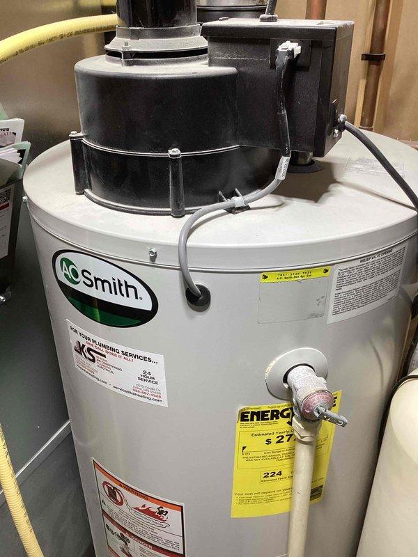 Performed warranty inspection for reported water heater leak at piping joint installed within past 30 days. Determined issue was not a leak but normal condensation forming where cold water inlet line runs adjacent to power vent, causing moisture when heater operates. No repair needed; A.O. Smith water heater functioning properly. Customer advised to monitor the progress joint and report if actual leakage occurs.