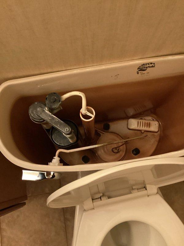 Responded to service call regarding malfunctioning toilet with fill valve issue. Upon inspection of Mansfield toilet, determined the mechanical flow control component had failed. Removed the defective fill valve and installed a new replacement unit. After restoration of water supply, verified proper filling function and successful toilet operation.