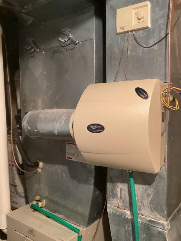 Responded to service call for A/C noise and leak concerns. Inspected system and identified connection issue with the Aprilaire humidifier mounted to the furnace. Sealed PVC condensate drain pipe joint that was leaking and verified proper system operation after repair.