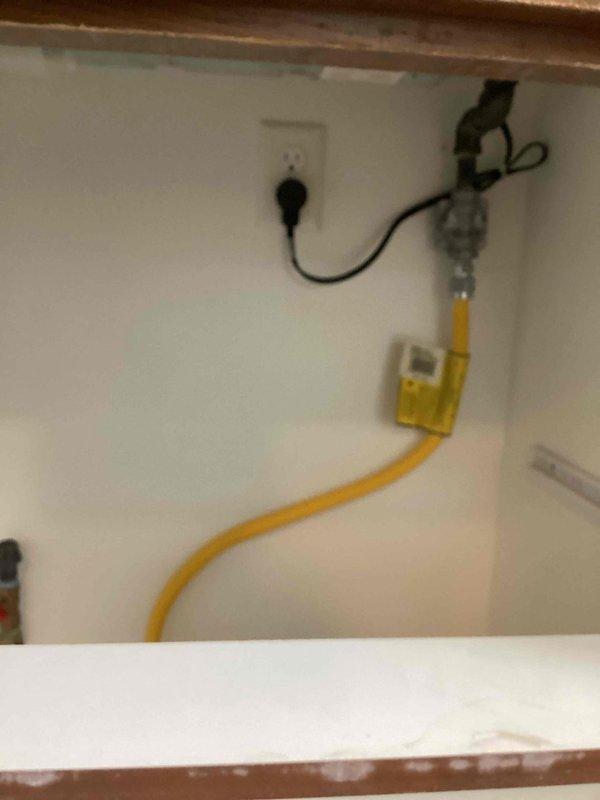 Successfully installed a new dedicated 50-amp circuit for an electric induction cooktop, converting the kitchen from gas to electric power. Ran wiring from the utility room through the basement living room wafer light, then fished to the stove location with necessary Sheetrock modifications to complete the installation. Final connections were made and system was tested for proper operation.