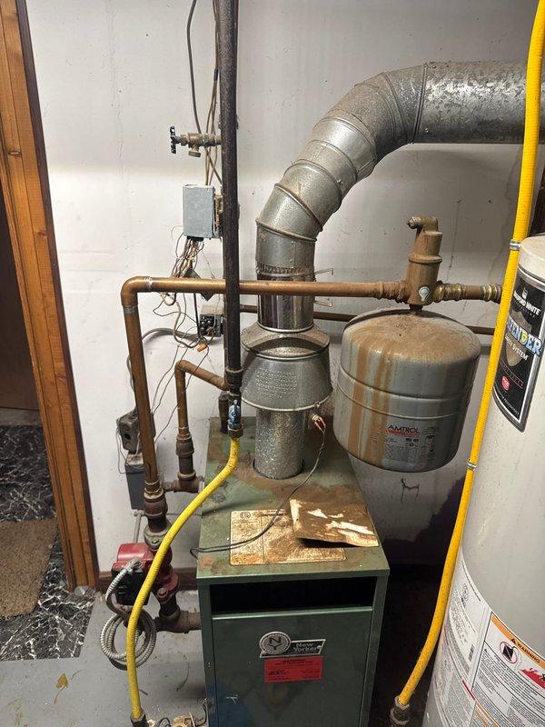 Responded to no-heat call for a 25-year-old New Yorker boiler. Diagnosed tripped high limit due to clogged heat exchanger. Reset limit to restore temporary operation. Recommended full replacement of aging unit as heat exchanger is significantly obstructed. Project manager scheduled to provide replacement estimate.