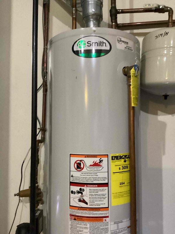 Responded to service call for A.O. Smith water heater with no hot water and flashing indicator light. Diagnosed issue as extinguished pilot light. Relit pilot successfully and restored unit to normal operation, informing customer that full hot water capacity (40 gallons) would be available within one hour.