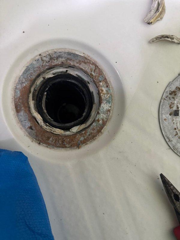 Responded to a service call regarding a leak from upstairs shower causing water spot on ceiling below. Diagnostic investigation revealed leak originating from damaged O-ring seal at drain assembly. Completed repair by replacing deteriorated O-ring and installing shims under drain pipe to ensure proper alignment and seal integrity.