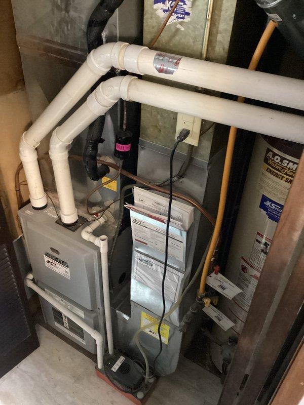 Responded to no heat call and diagnosed water accumulation in pressure switch causing ignition failure. Removed water from the pressure switch, test ran the furnace, and conducted CO safety check. System showed significant corrosion and rust on interior components indicating age-related wear, but restored proper operation.