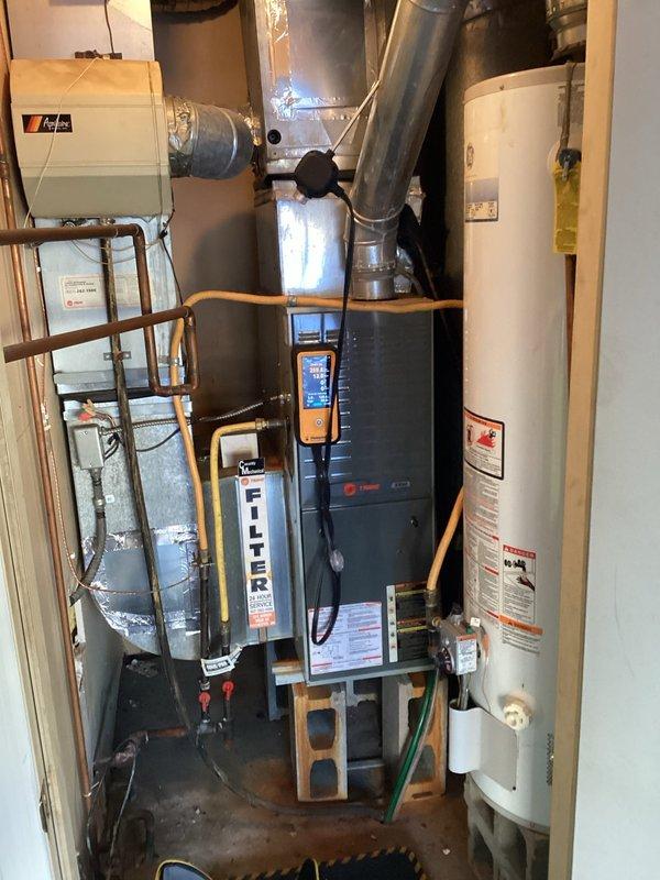 Responded to no heat complaint on 10+ year old Trane furnace system. Diagnosed weak blower motor capacitor causing heating failure. Replaced capacitor, restoring proper system operation and heat production.