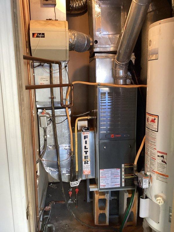 Responded to no heat complaint on 10+ year old Trane furnace system. Diagnosed weak blower motor capacitor causing heating failure. Replaced capacitor, restoring proper system operation and heat production.